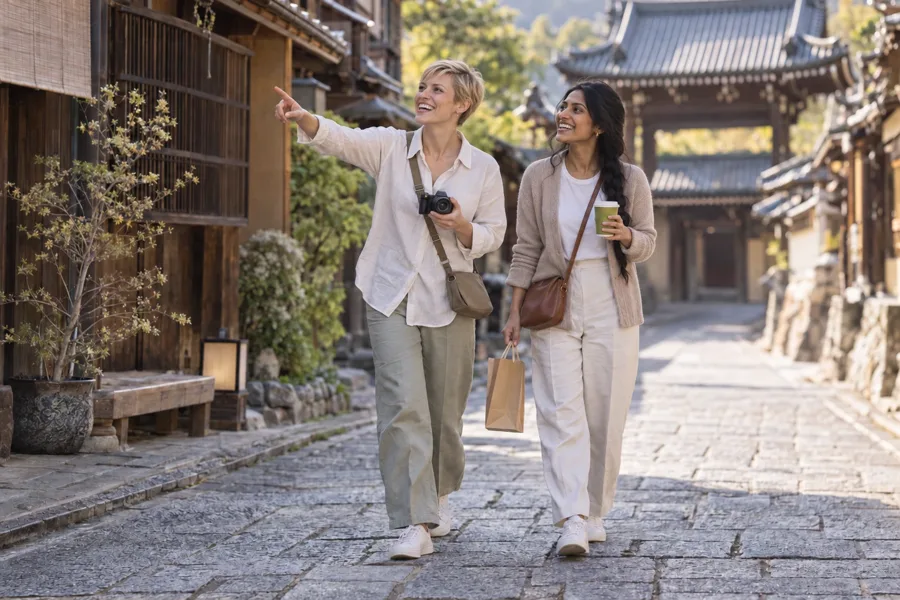 Two travellers exploring a historic street in Tokyo